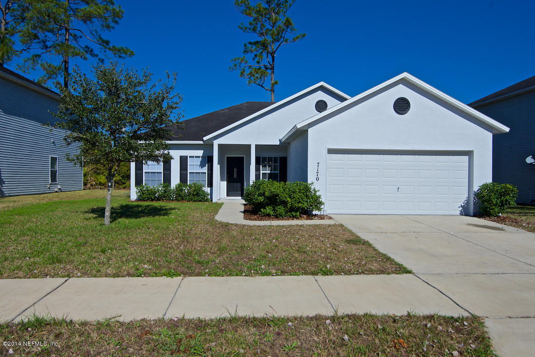 7170 Rampart Ridge Circle West Jacksonville, FL 32244 - Photo 1 of 22 a front view of a house with a yard