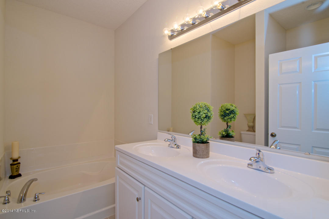 7170 Rampart Ridge Circle West Jacksonville, FL 32244 - Photo 16 of 22 a bathroom with a sink and a bathtub