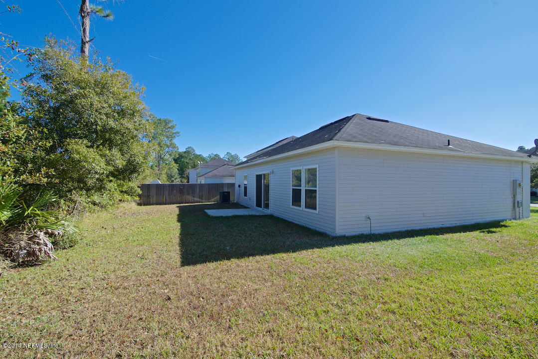 7170 Rampart Ridge Circle West Jacksonville, FL 32244 - Photo 20 of 22 a front view of a house with a yard