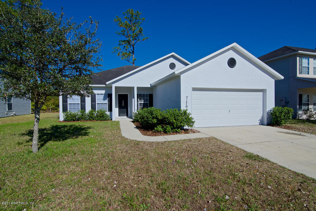 7170 Rampart Ridge Circle West Jacksonville, FL 32244 - Photo 2 of 22 a front view of a house with a yard