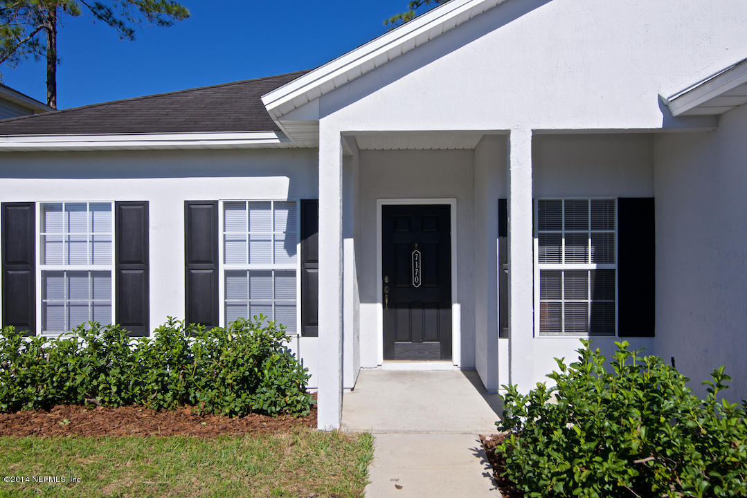 7170 Rampart Ridge Circle West Jacksonville, FL 32244 - Photo 21 of 22 a front view of a building with garden