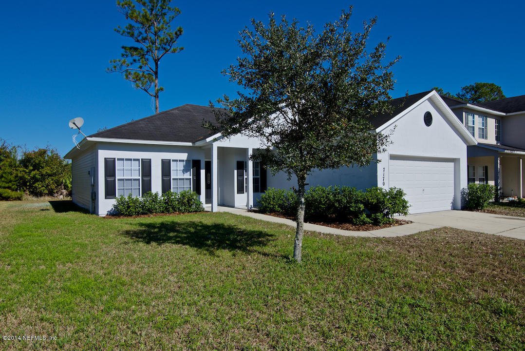 7170 Rampart Ridge Circle West Jacksonville, FL 32244 - Photo 3 of 22 a front view of a house with a yard