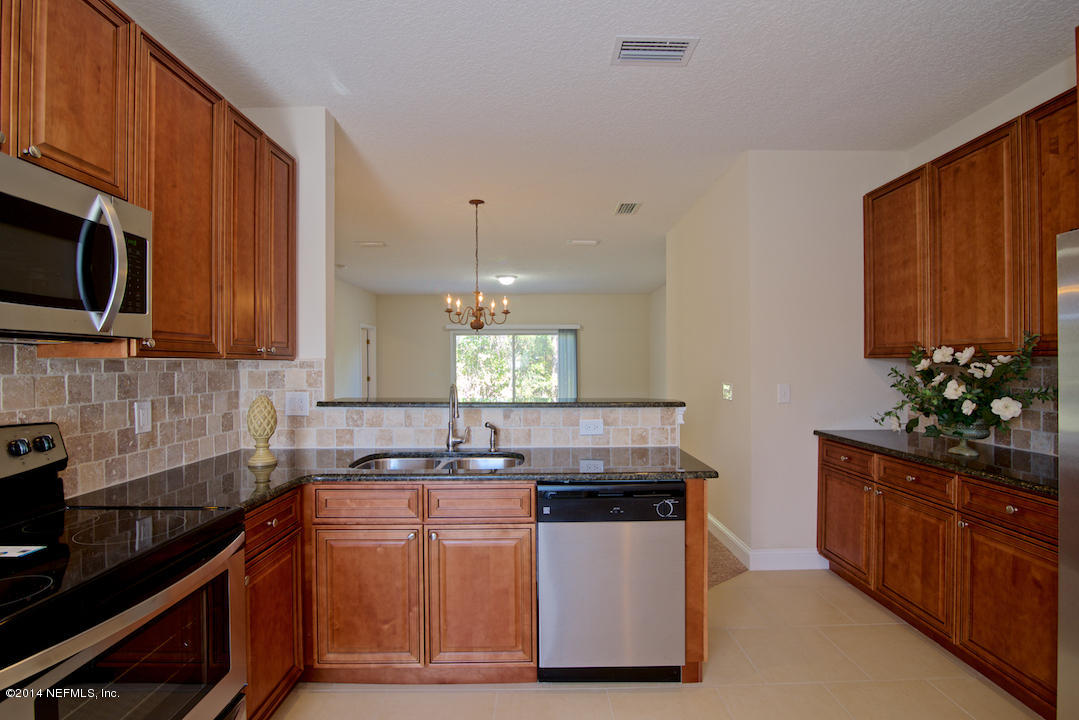 7170 Rampart Ridge Circle West Jacksonville, FL 32244 - Photo 8 of 22 a kitchen with stainless steel appliances granite countertop a stove a sink dishwasher and microwave oven