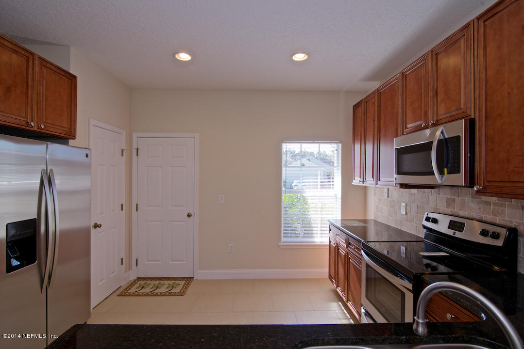 7170 Rampart Ridge Circle West Jacksonville, FL 32244 - Photo 9 of 22 a kitchen with stainless steel appliances granite countertop a stove a refrigerator and a microwave