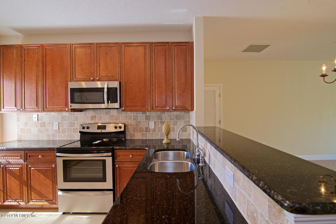 7170 Rampart Ridge Circle West Jacksonville, FL 32244 - Photo 10 of 22 a kitchen with granite countertop a stove and a microwave