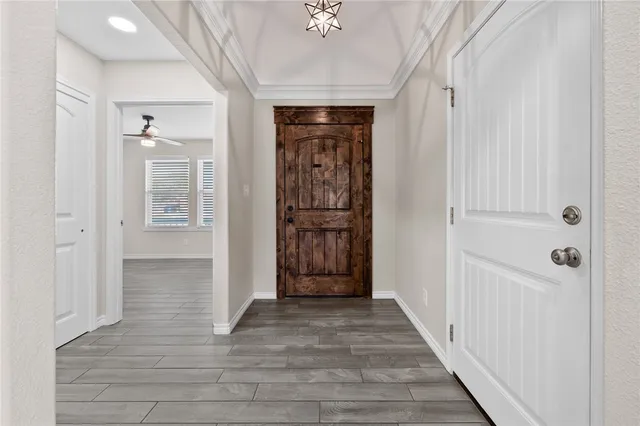 a view of a hallway with wooden floor and closet