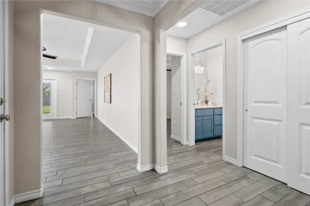 a view of a hallway with wooden floor
