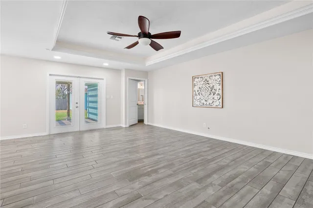 a view of a livingroom with a hardwood floor and a ceiling fan