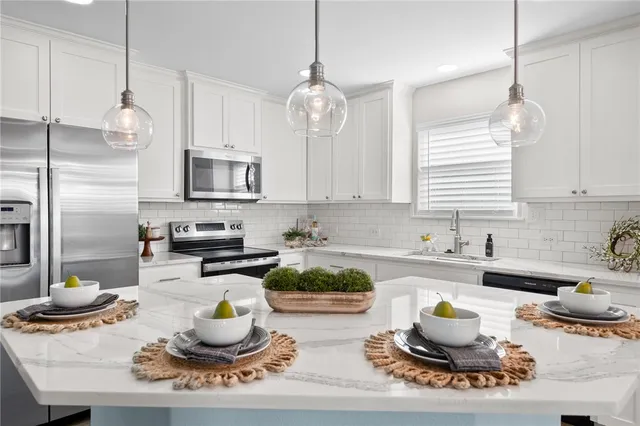 a kitchen with sink a stove and cabinets