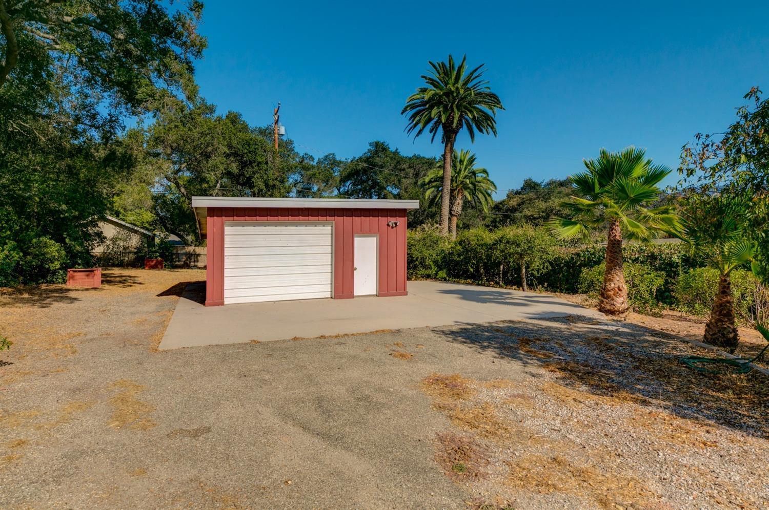 516 Palomar Road Ojai, CA 93023 - Photo 34 of 45 a front view of a house with a yard and garage