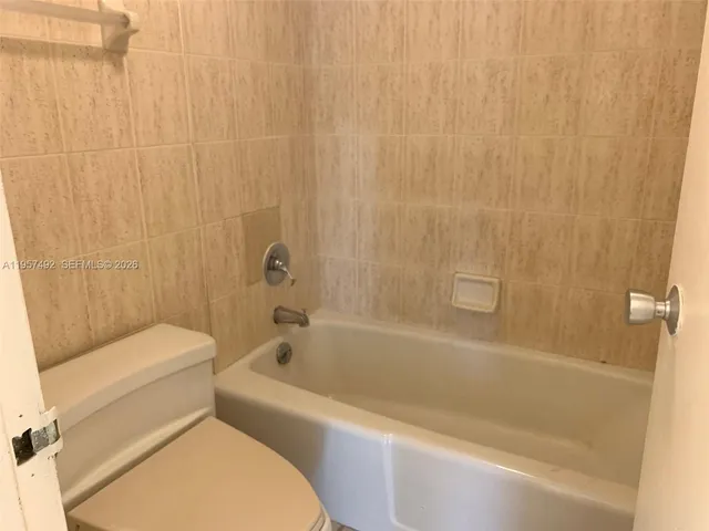 a bathroom with a toilet and bathtub