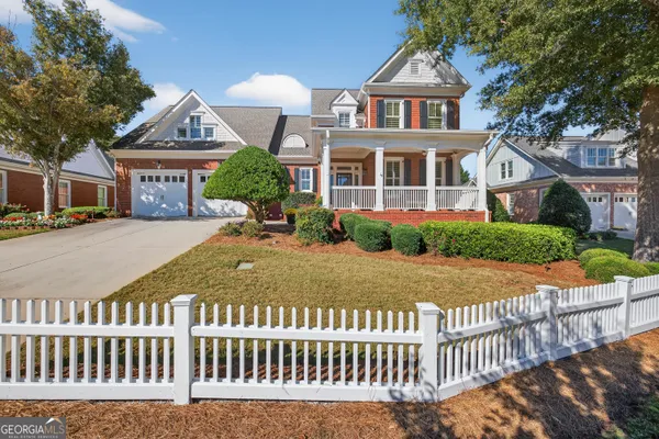 a front view of a house with a yard and a garden