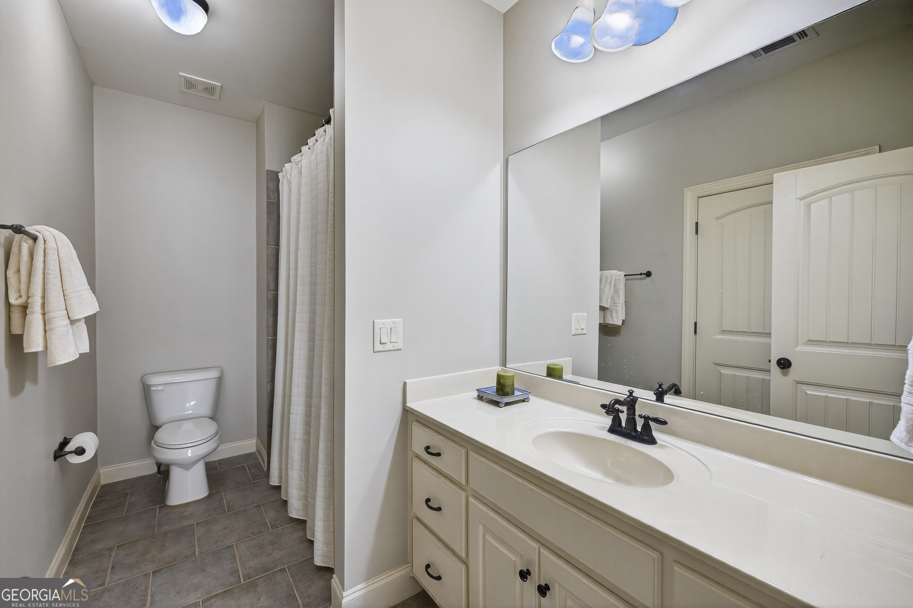 675 Garden Circle Statham, GA 30666 - Photo 63 of 98 a bathroom with a double vanity sink toilet and mirror