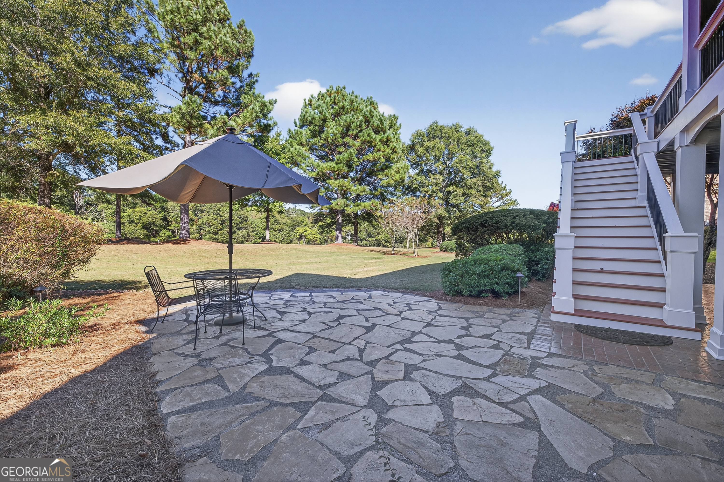 675 Garden Circle Statham, GA 30666 - Photo 10 of 98 a view of a patio with a table and chairs under an umbrella