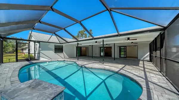 a house with swimming pool in front of it