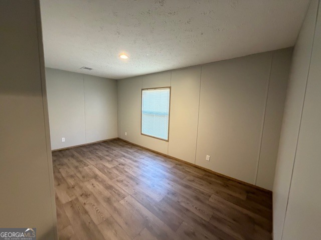 907 Orianna Road East Dublin, GA 31027 - Photo 12 of 21 an empty room with wooden floor and windows