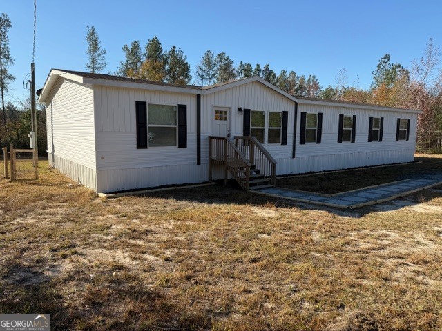 907 Orianna Road East Dublin, GA 31027 - Photo 3 of 21 a house with trees in the background