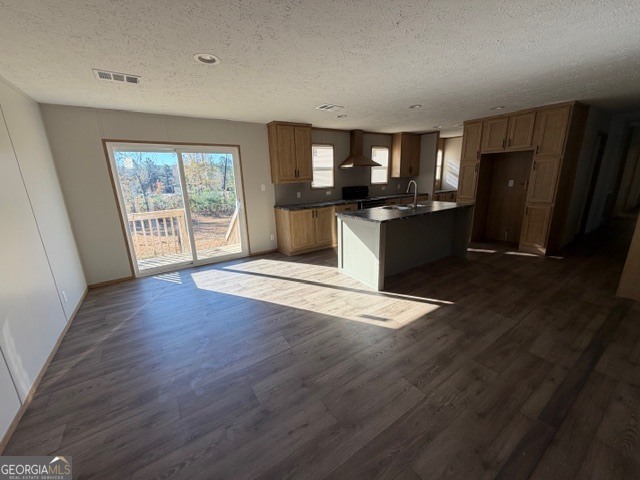 907 Orianna Road East Dublin, GA 31027 - Photo 7 of 21 a kitchen with stainless steel appliances kitchen island granite countertop a refrigerator a sink dishwasher and a black countertops with wooden floor
