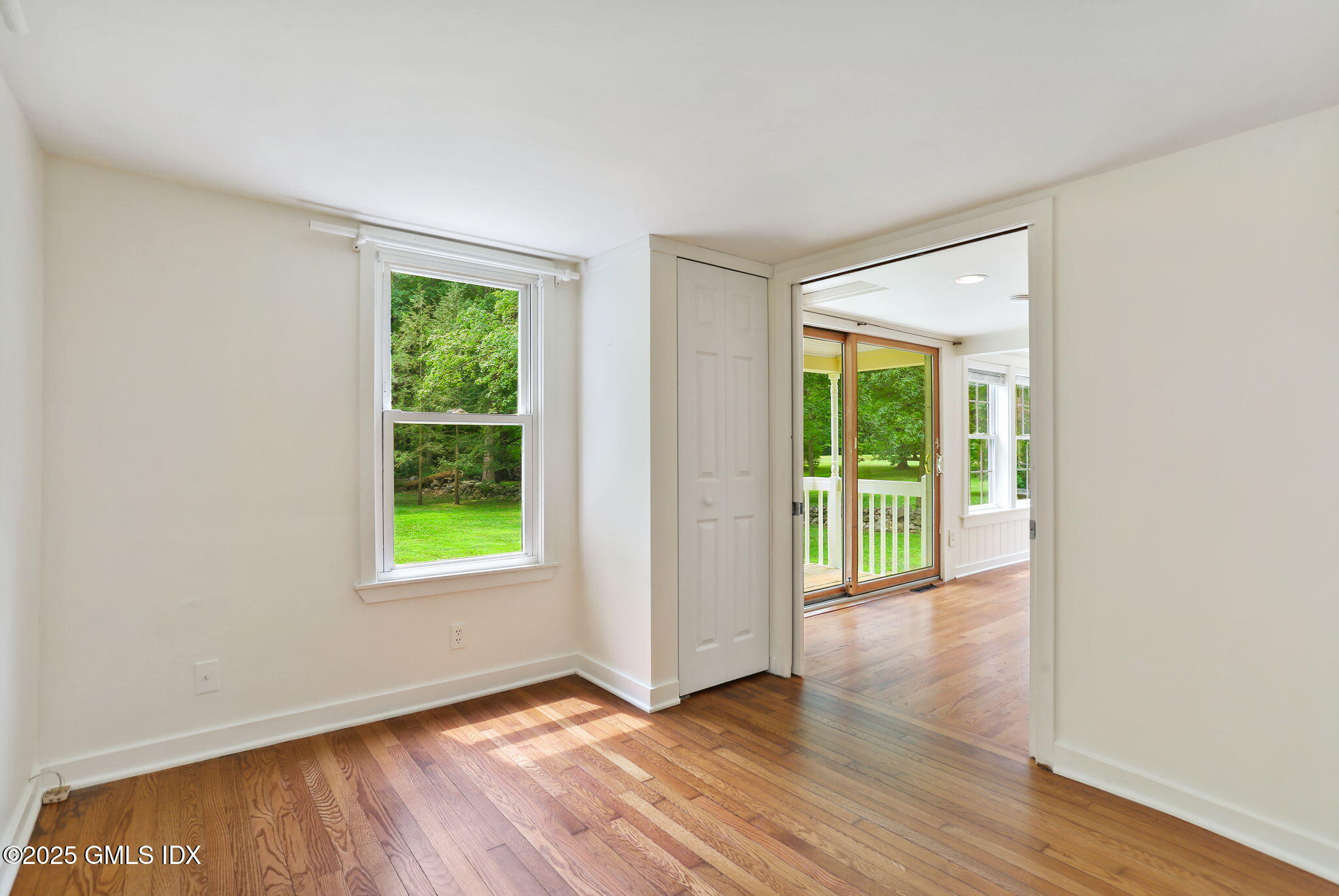 27 Seeley Road Wilton, CT 06897 - Photo 12 of 27 an empty room with wooden floor and windows