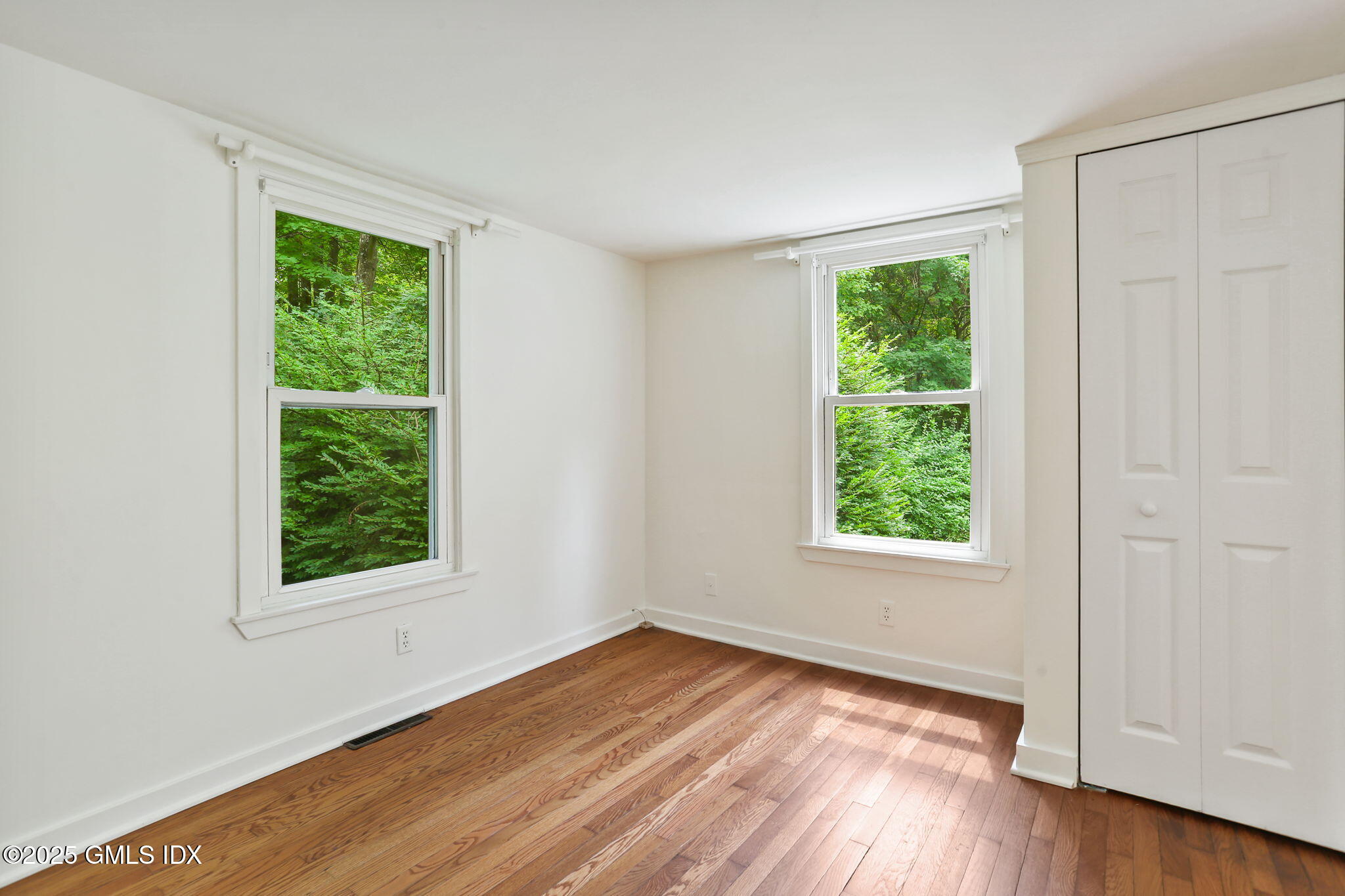 27 Seeley Road Wilton, CT 06897 - Photo 13 of 27 an empty room with wooden floor and windows