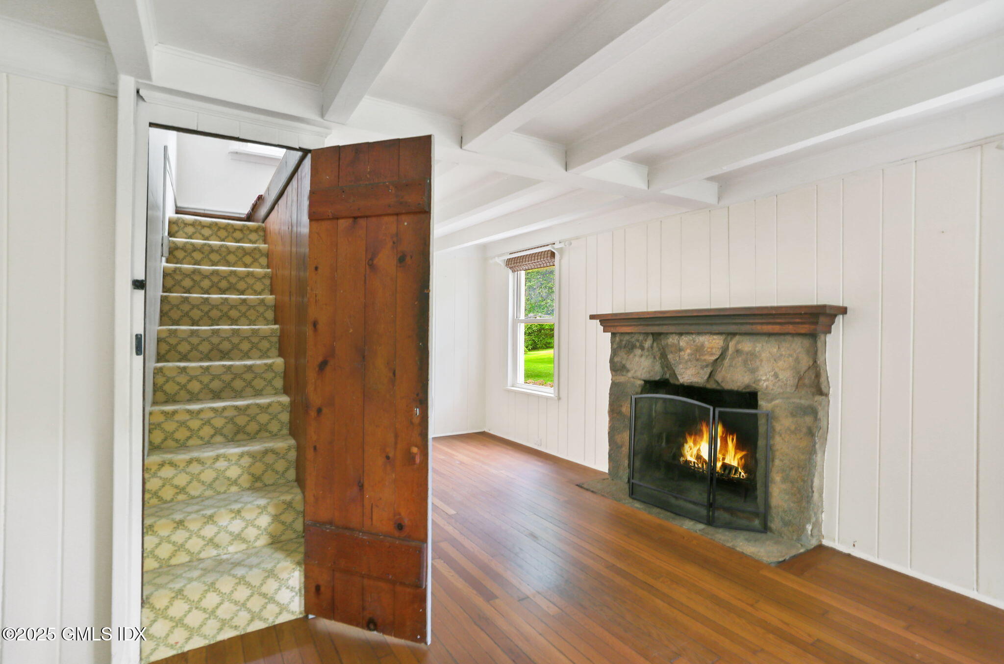 27 Seeley Road Wilton, CT 06897 - Photo 18 of 27 a view of an empty room with wooden floor fireplace and a window
