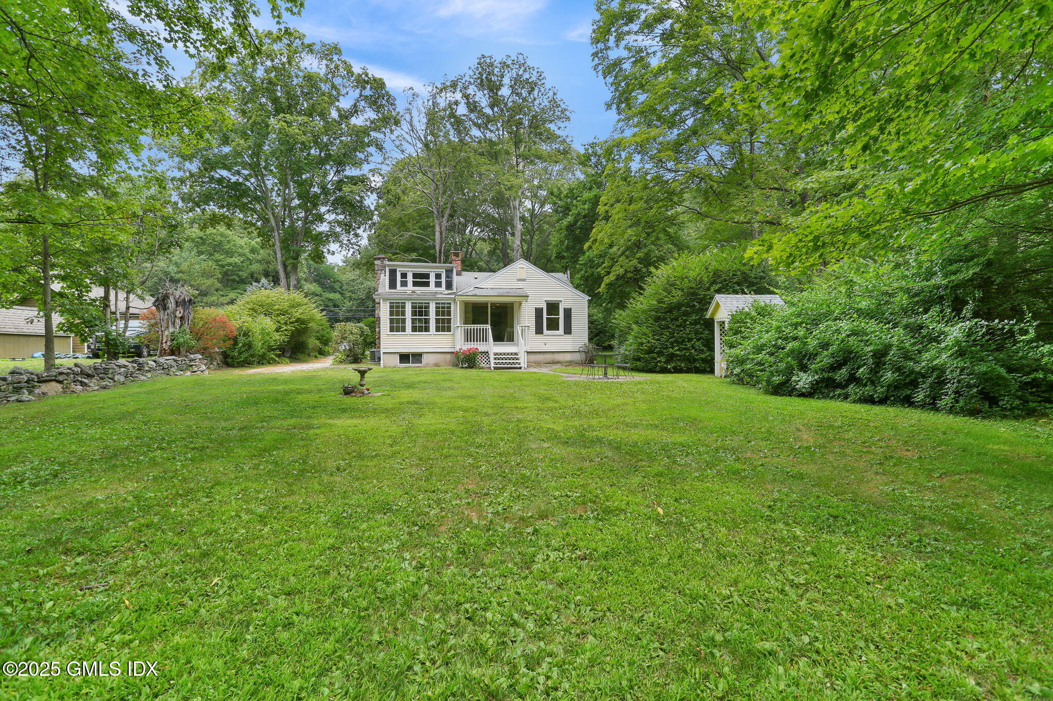 27 Seeley Road Wilton, CT 06897 - Photo 25 of 27 a front view of a house with yard and green space