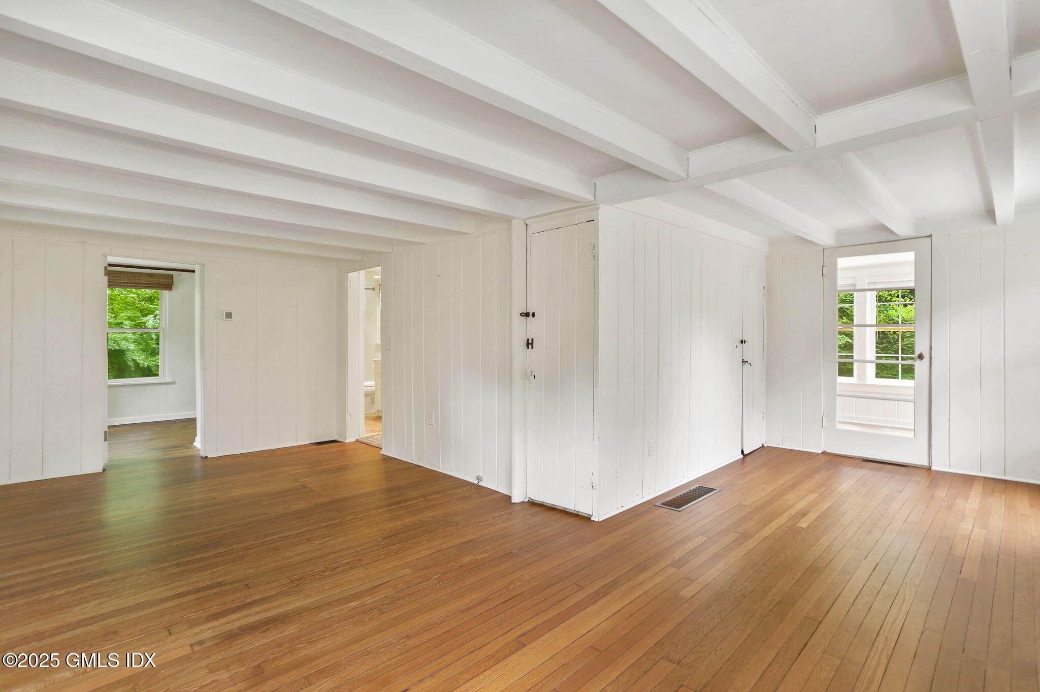 27 Seeley Road Wilton, CT 06897 - Photo 3 of 27 an empty room with wooden floor and windows