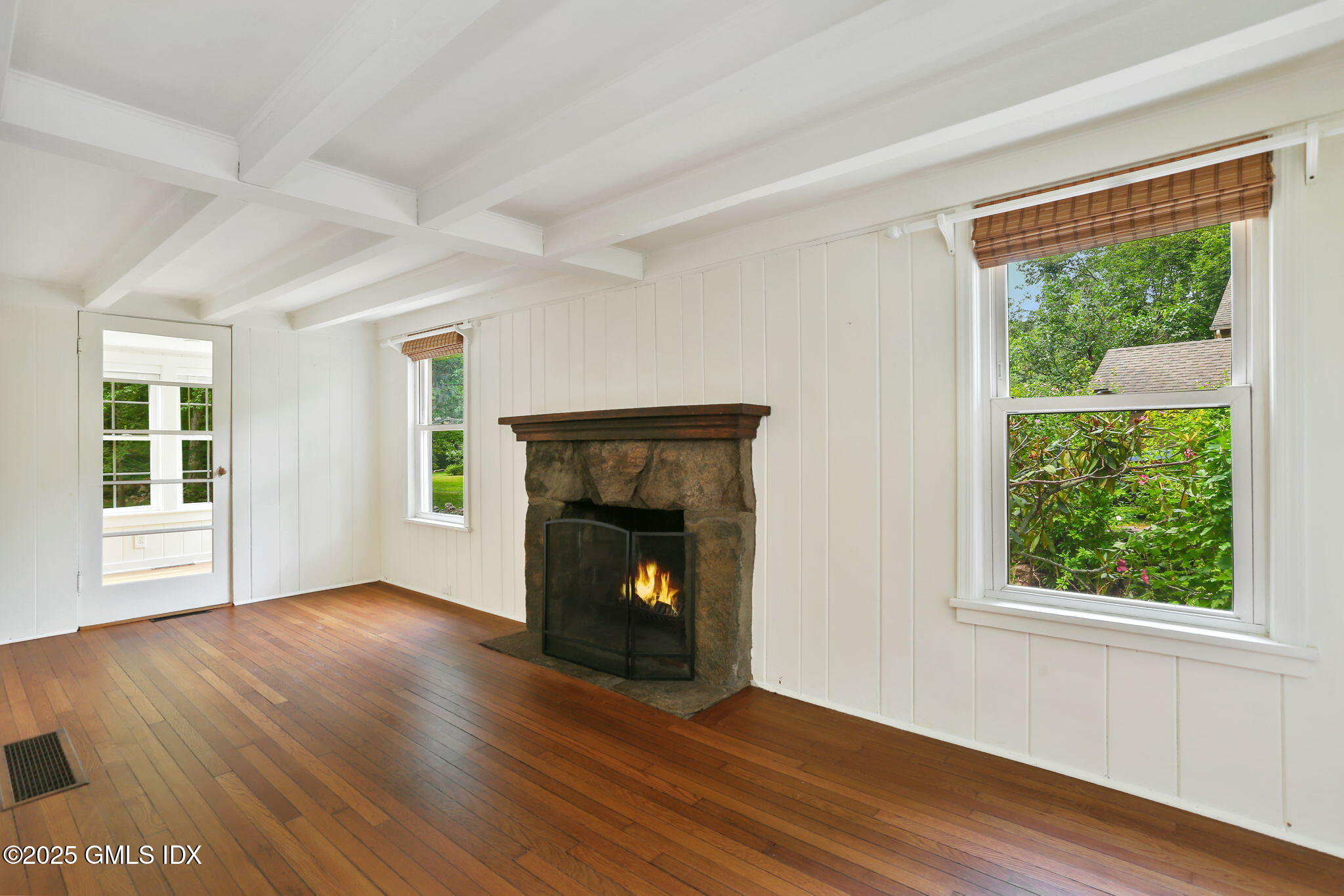 27 Seeley Road Wilton, CT 06897 - Photo 5 of 27 a view of an empty room with wooden floor and a window