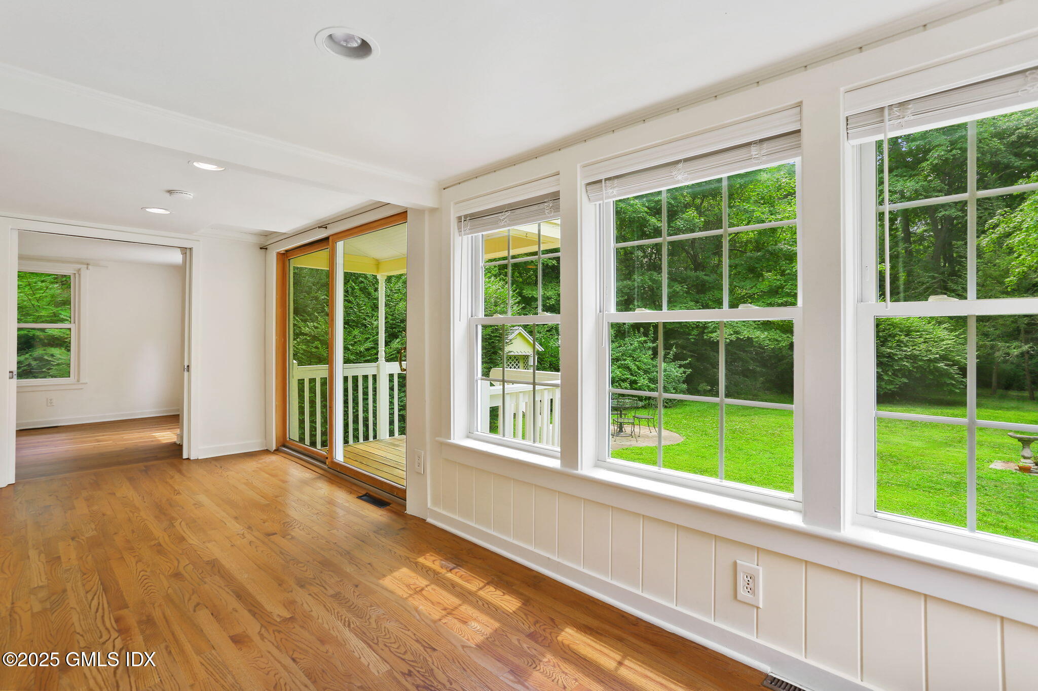 27 Seeley Road Wilton, CT 06897 - Photo 7 of 27 a view of an empty room with wooden floor and a window