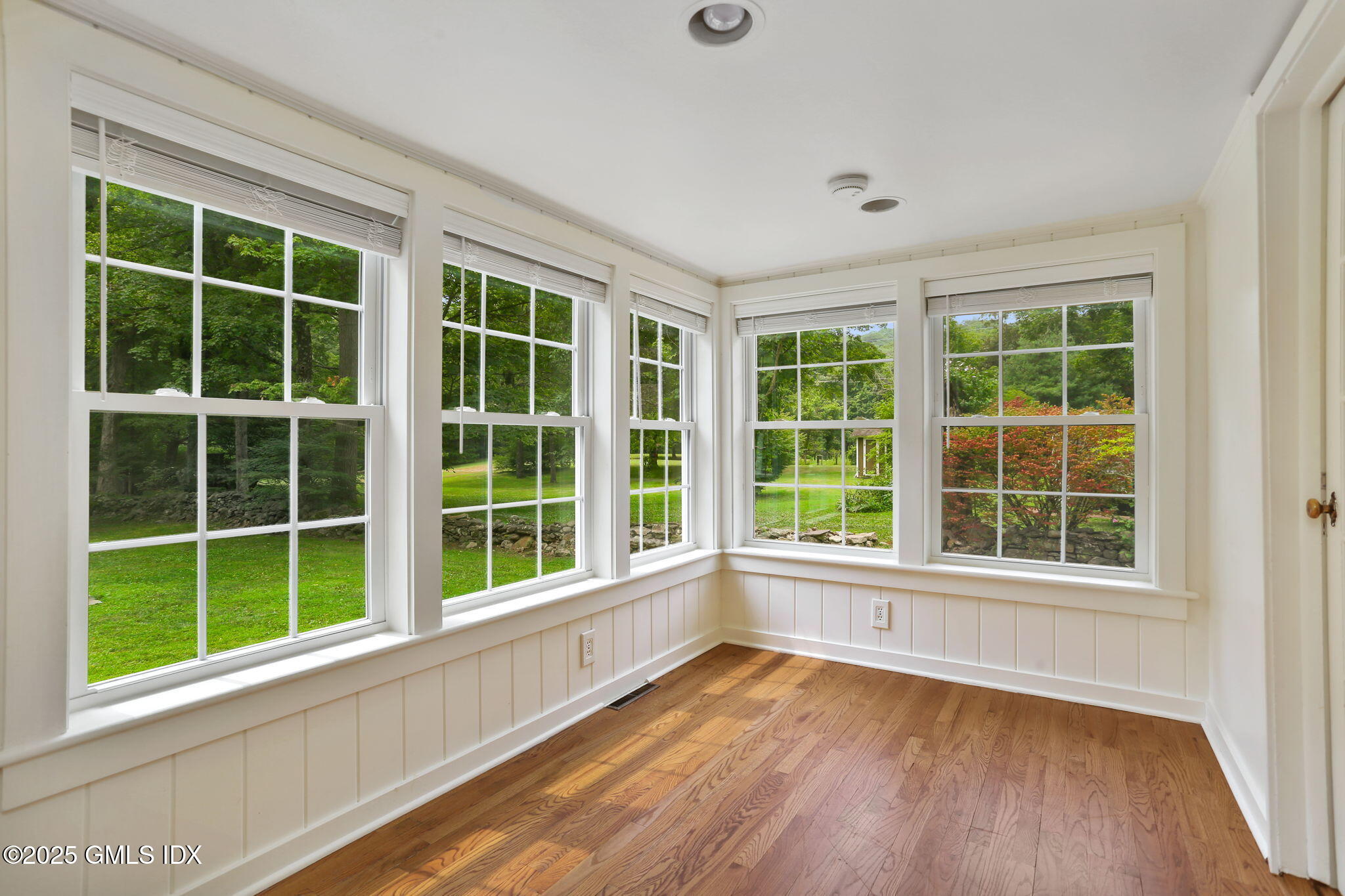 27 Seeley Road Wilton, CT 06897 - Photo 9 of 27 a view of an empty room with a window and wooden floor
