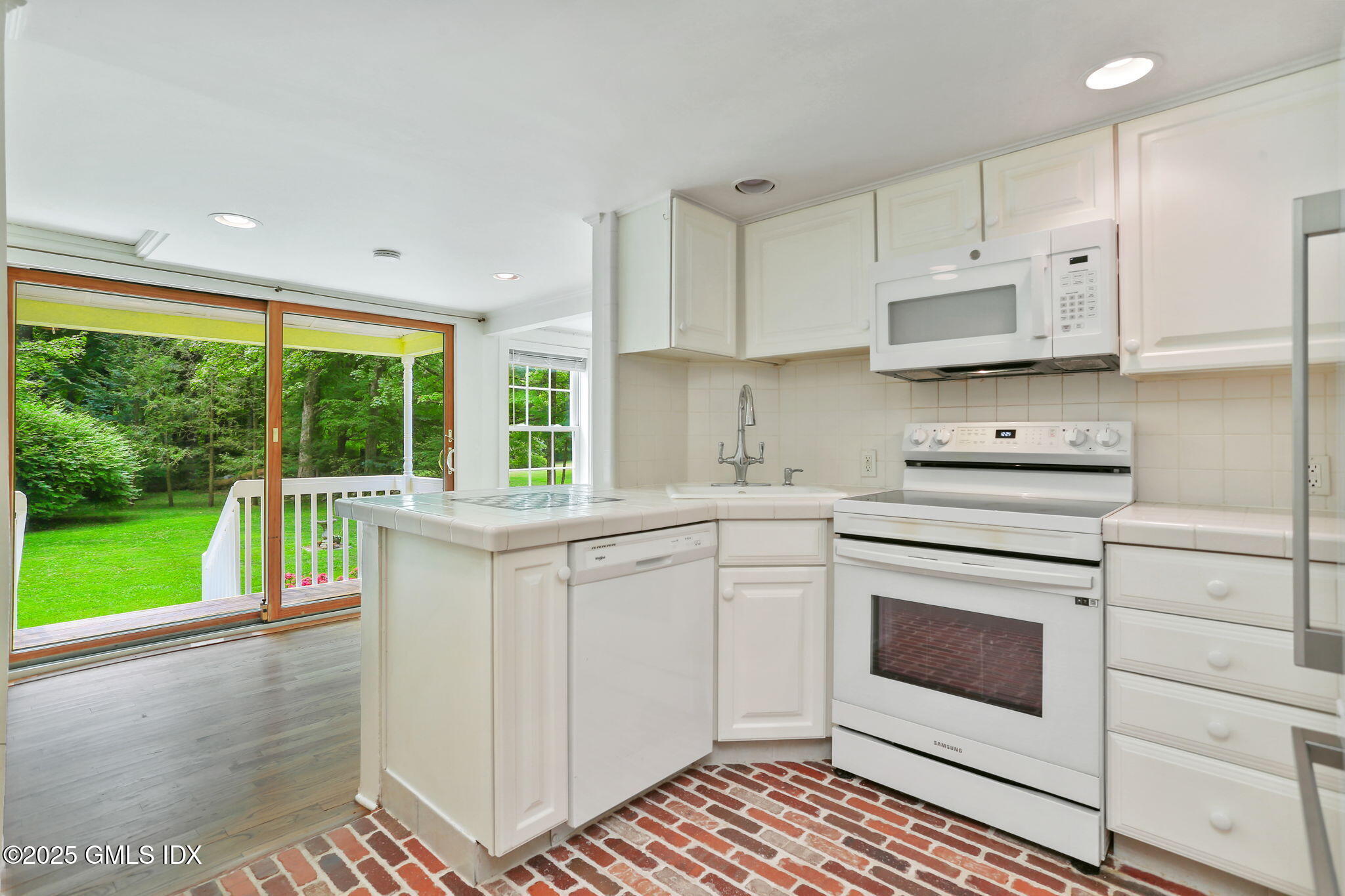27 Seeley Road Wilton, CT 06897 - Photo 10 of 27 a kitchen with a stove a sink and a microwave