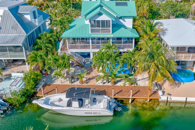 a aerial view of a house with a yard and sitting area
