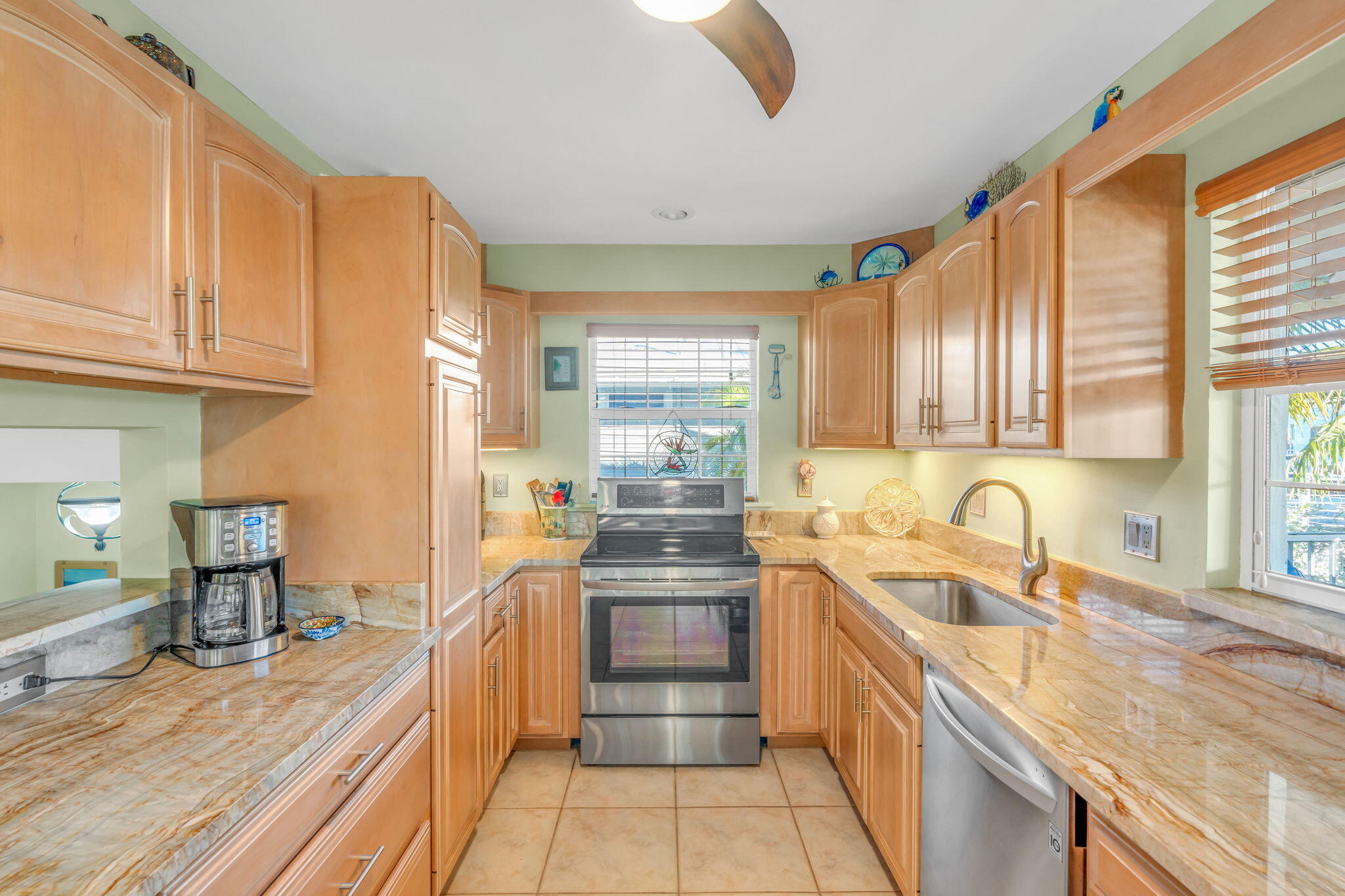 28560 Doubloon Road Summerland Key, FL 33042 - Photo 18 of 52 a kitchen with granite countertop a sink stove and cabinets