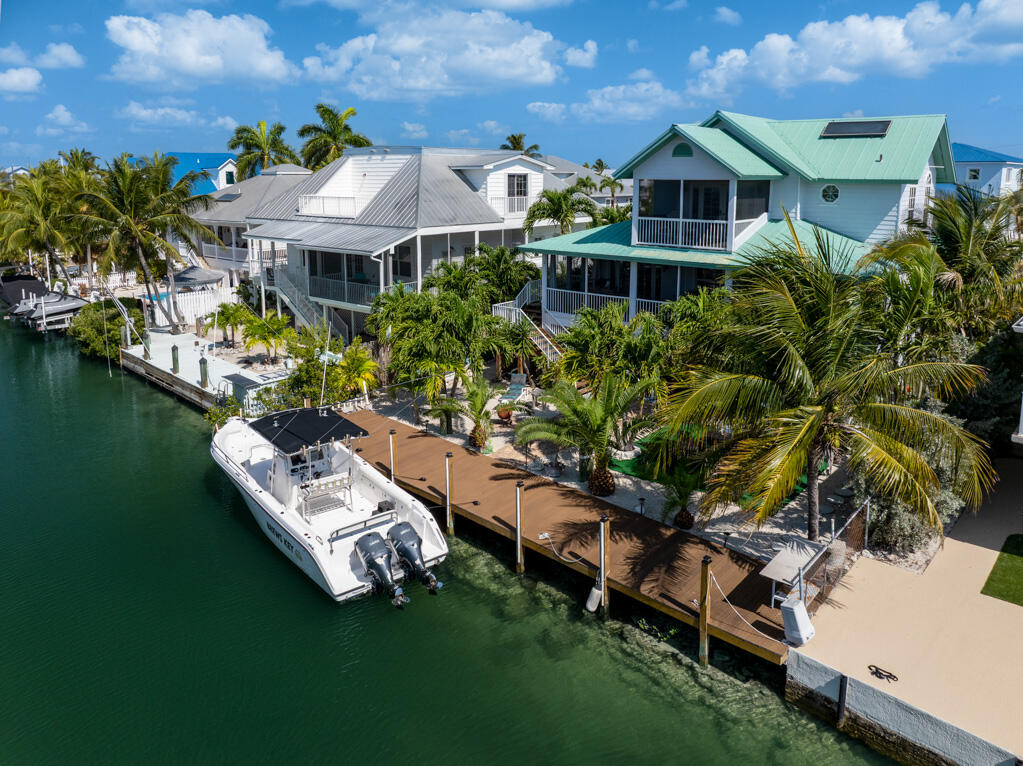 28560 Doubloon Road Summerland Key, FL 33042 - Photo 2 of 52 a aerial view of a house with swimming pool garden and lake view