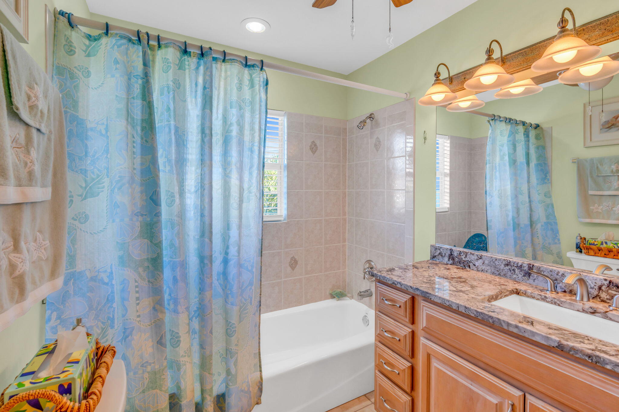 28560 Doubloon Road Summerland Key, FL 33042 - Photo 22 of 52 a bathroom with a granite countertop sink a mirror and a shower