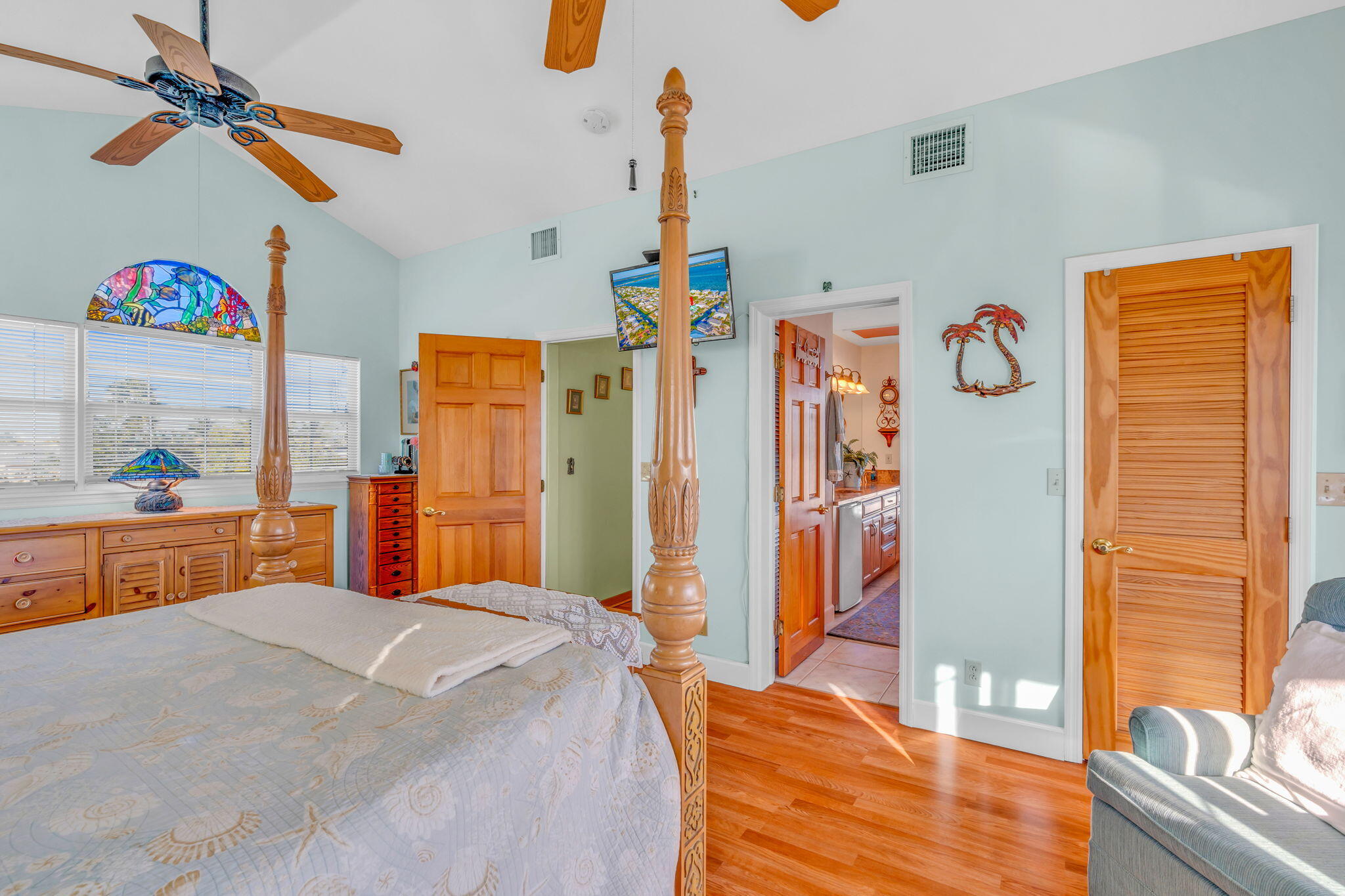 28560 Doubloon Road Summerland Key, FL 33042 - Photo 32 of 52 a bedroom with a bed and a chandelier