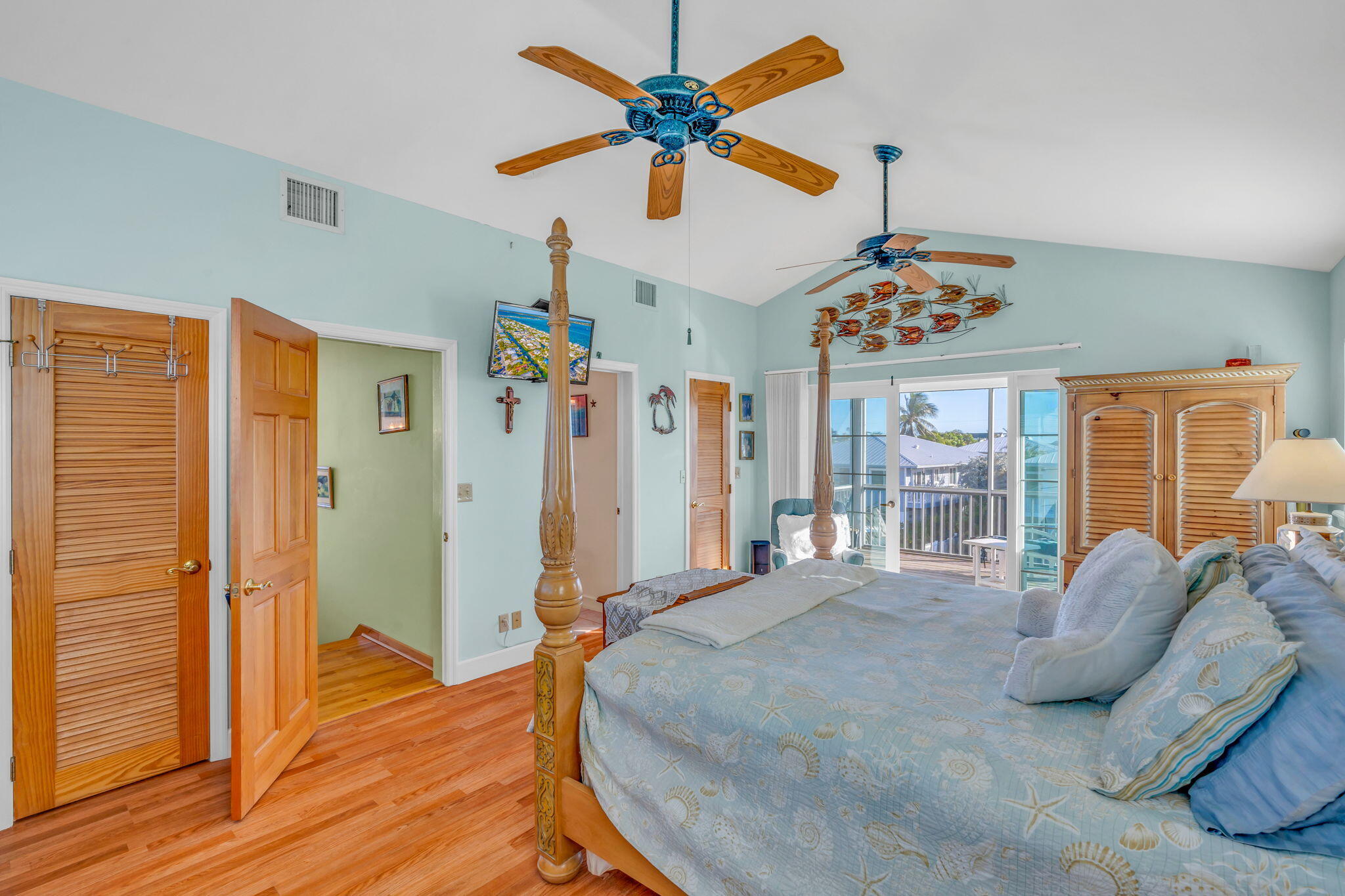 28560 Doubloon Road Summerland Key, FL 33042 - Photo 33 of 52 a spacious bedroom with a bed and a chandelier