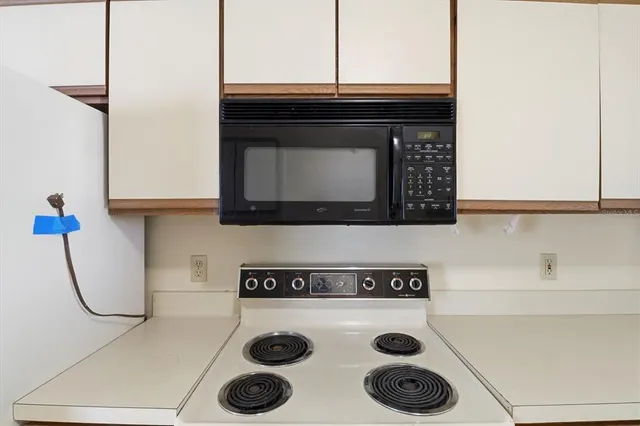 a stove top oven sitting inside of a kitchen