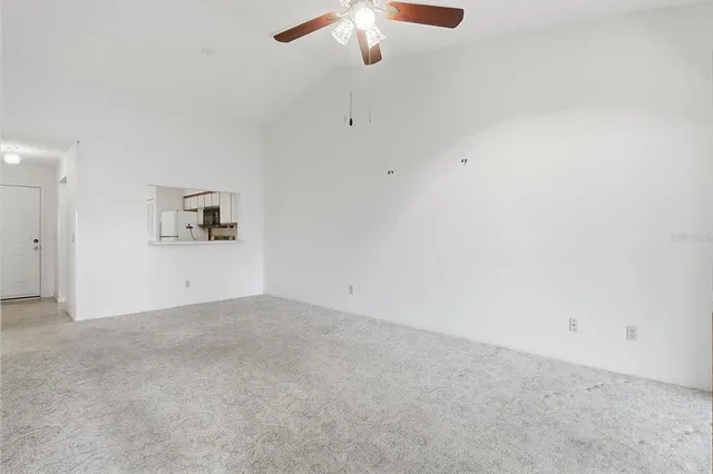 a view of a room with a ceiling fan