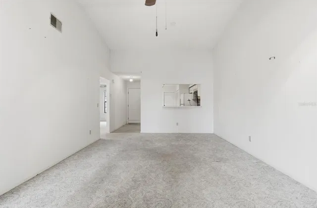 an empty room with a empty space and chandelier fan