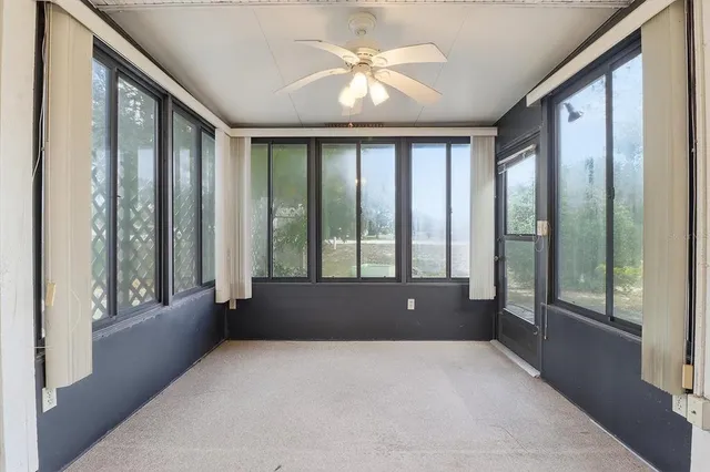 an empty room with windows and entryway