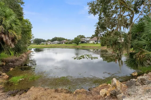 a view of a lake with couches in the patio