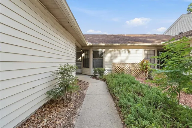 a pathway of a house with a yard