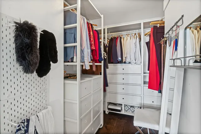 a view of walk in closet with clothes