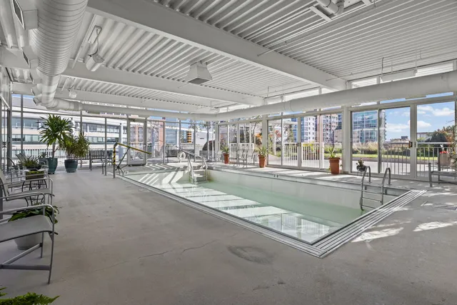 a view of a gym with pool table and chairs