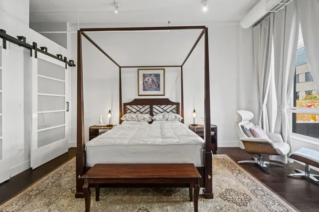 a bed room with a bed window and a table