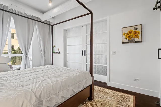 a bedroom with a bed and a window