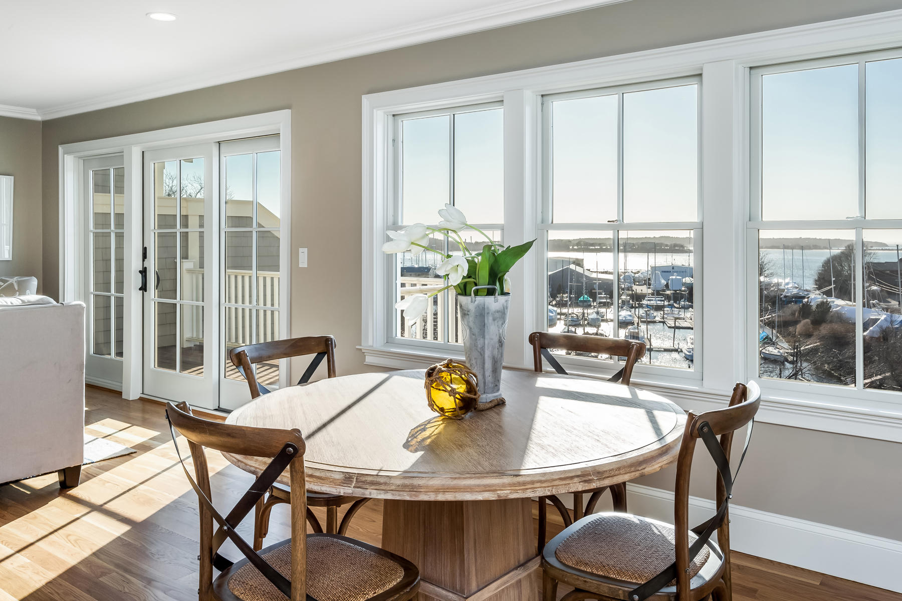 1090 Shore Road, Unit 5 Pocasset, MA 02559 - Photo 13 of 32 a dining room with furniture a chandelier and wooden floor