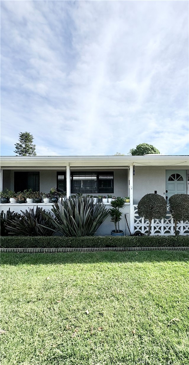 1680 Monterey Road Seal Beach, CA 90740 - Photo 1 of 19 a front view of a house with garden
