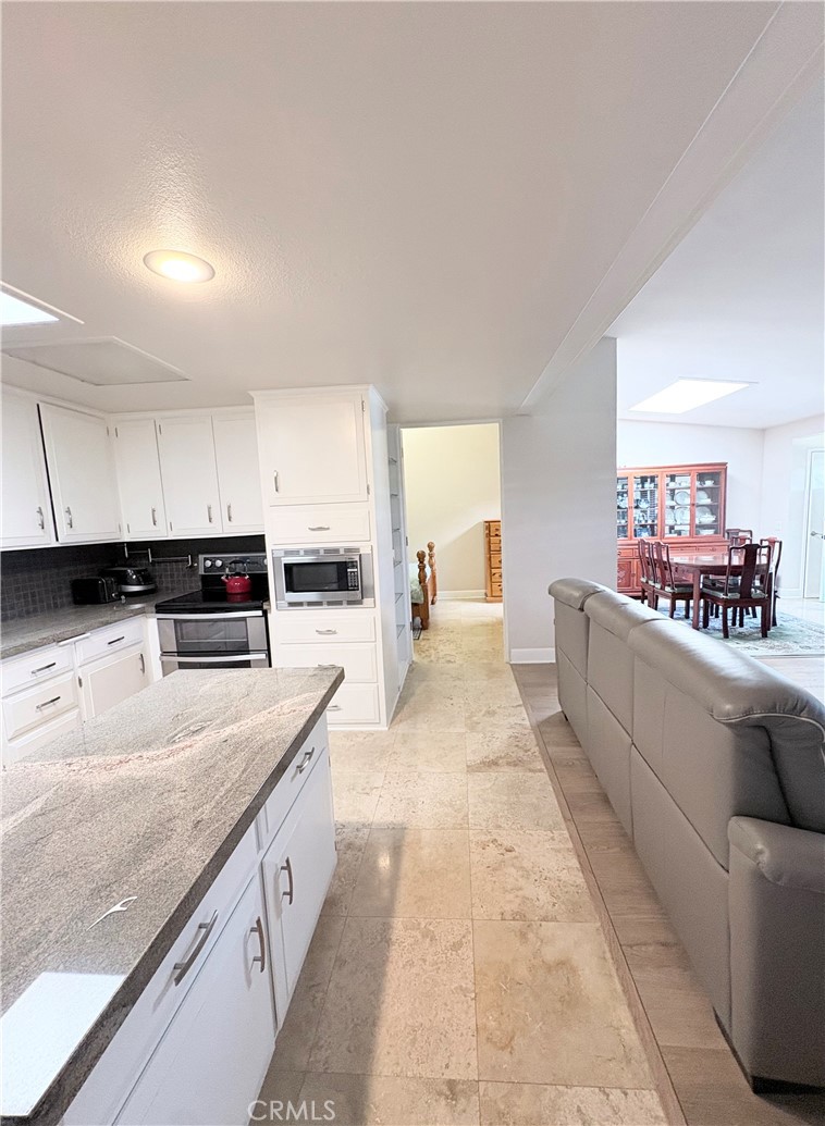 1680 Monterey Road Seal Beach, CA 90740 - Photo 12 of 19 a large kitchen with kitchen island a stove a sink and a refrigerator